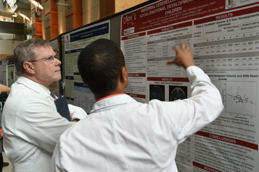 Student Josh Bridges explains his research to Pediatric Surgery Chief Brad Warner, MD