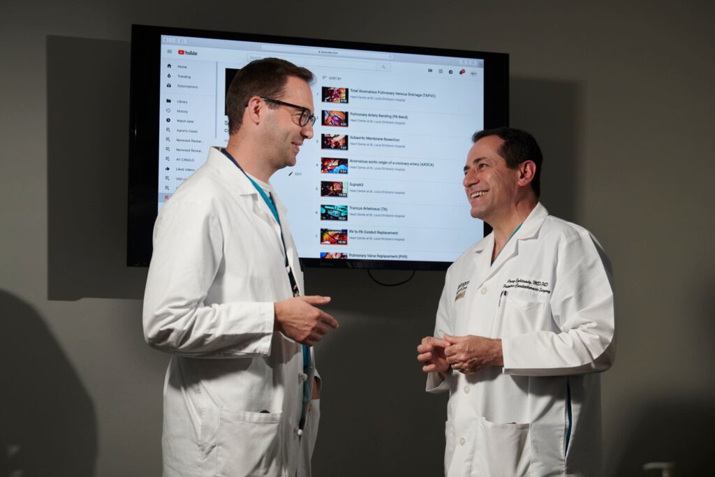 Clinical fellow Timothy Lancaster, MD, left, talkswith Pirooz Eghtesady, MD, Ph