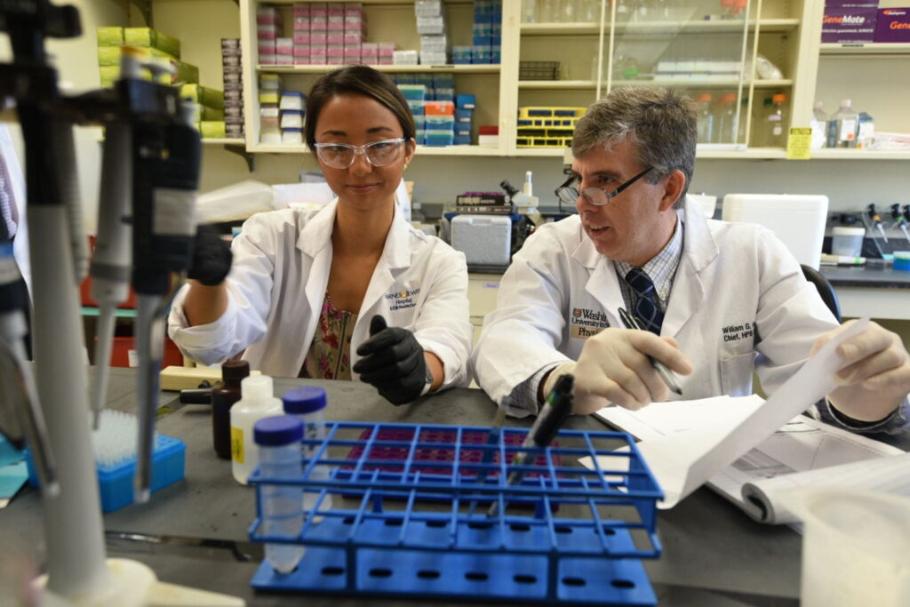 Doctor Hawkins in the research laboratory with surgical oncology fellow