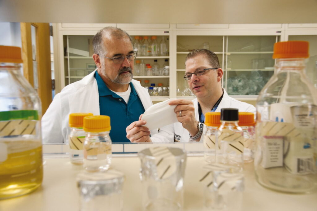 Doctor Bochicchio examining surgical mesh in lab