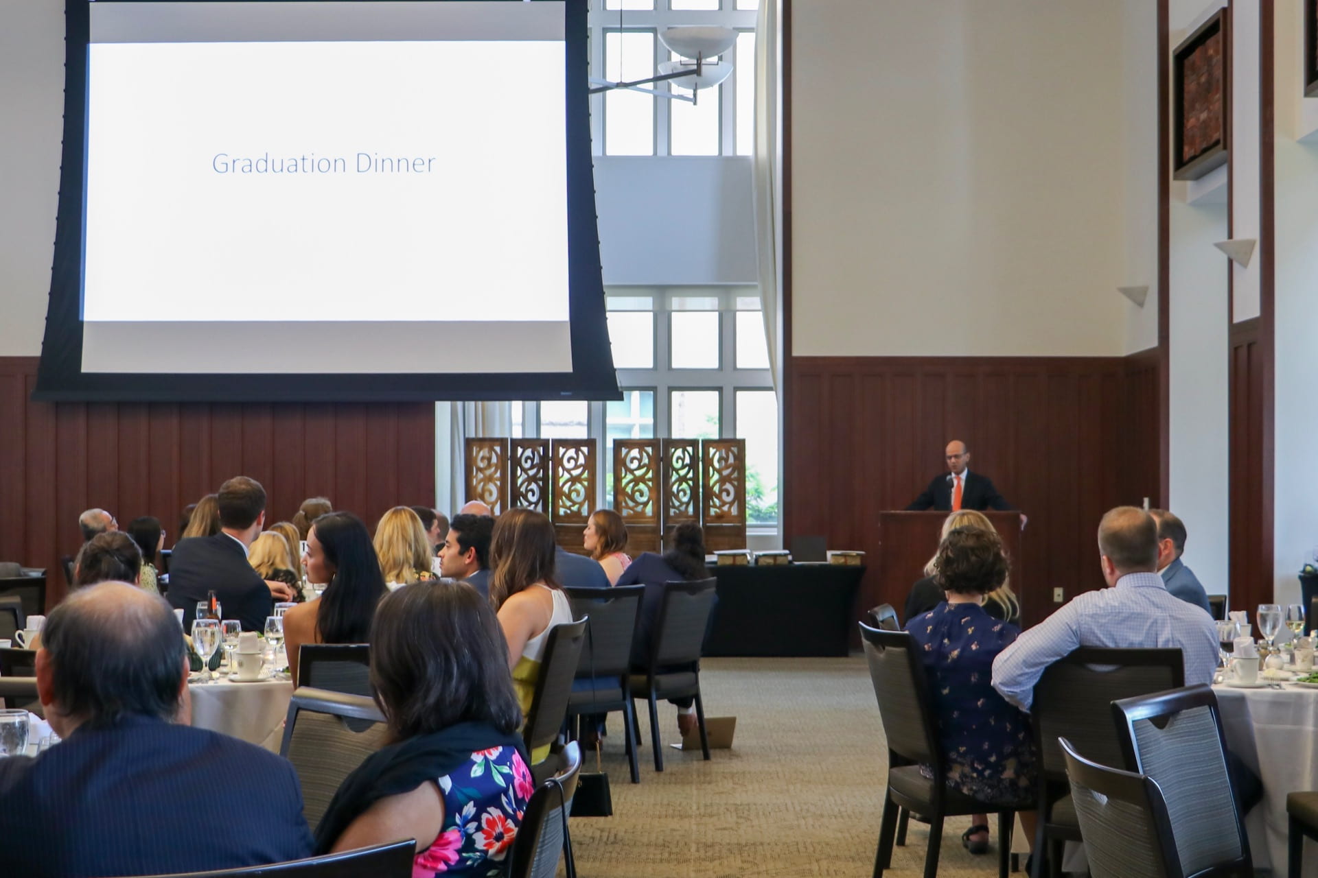 Bhayani at podium in front of audience at urology graduation in banquet room