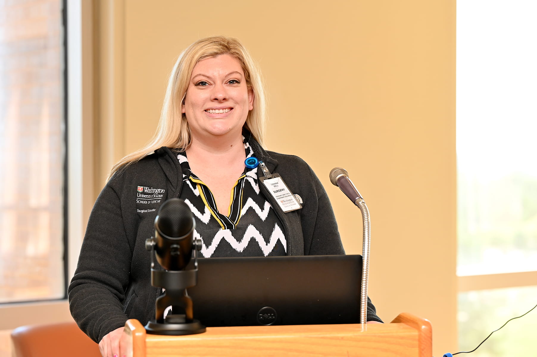 Leanna Bell at podium with microphone