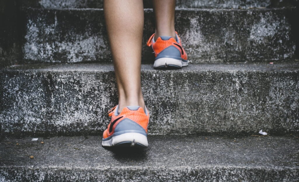 Photo of a person walking up steps