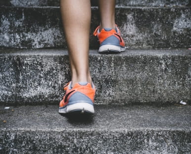 Photo of a person walking up steps