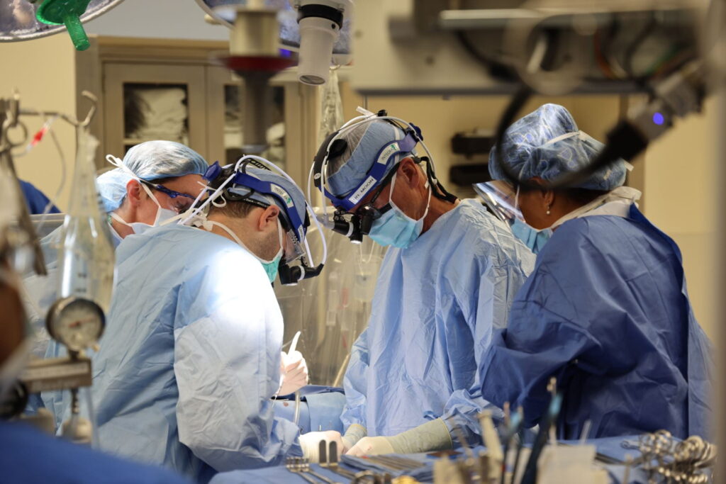 Marc Moon, MD, second from right, operates with surgical team