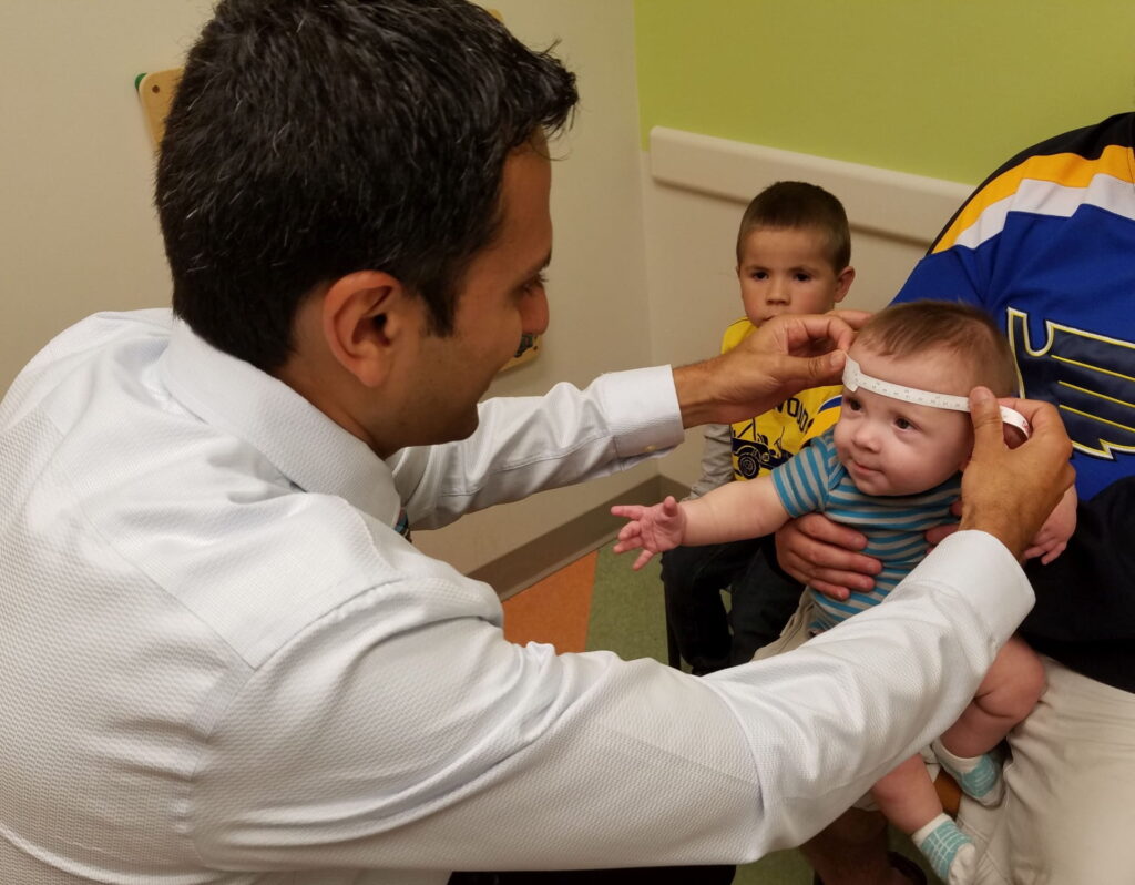 Doctor Patel measures a child's head