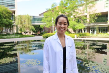 Education fellow Britta Han standing in front of the tranquility pond on the Washington University medical campus