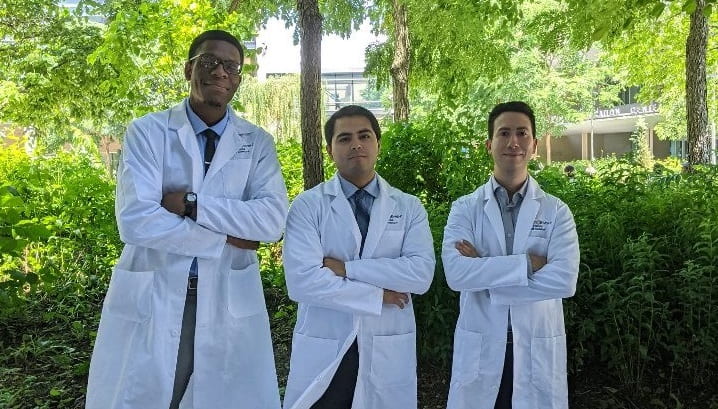 Dr. Thomasi alongside two fellow physicians