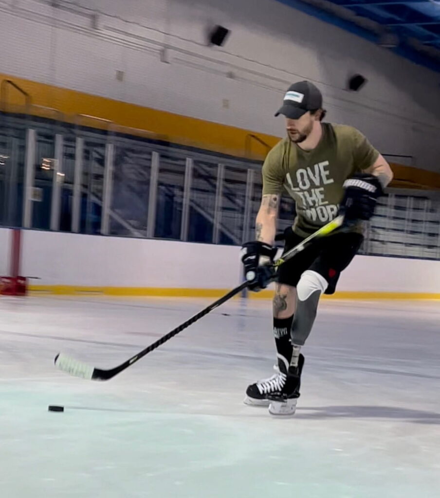 Sam Schaefer using a special prosthetic to play hockey