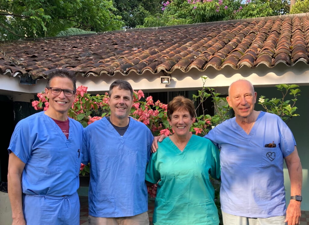 Surgeons and SOfA founders in blue and green scrubs outside medical facility in El Salvador