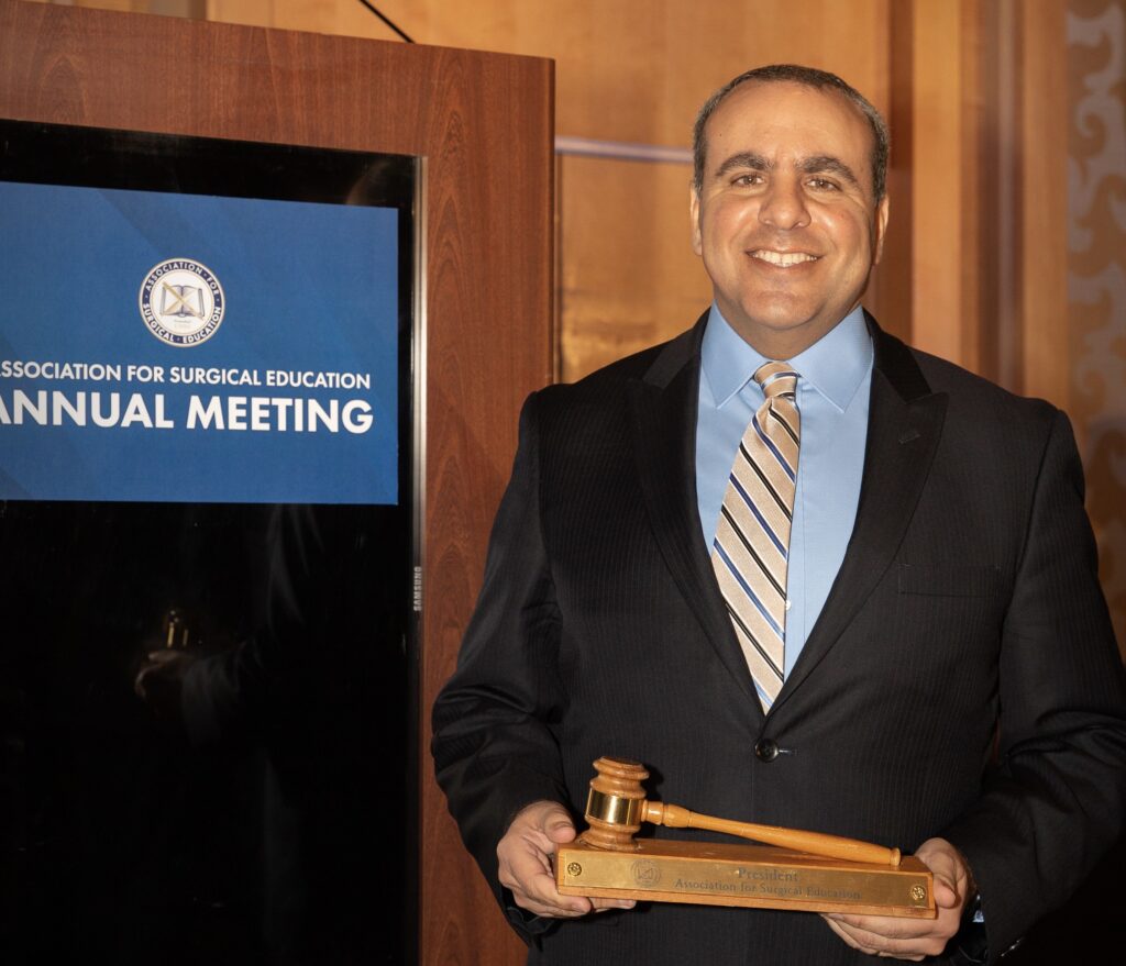 Michael Awad holding gavel at ASE annual meeting